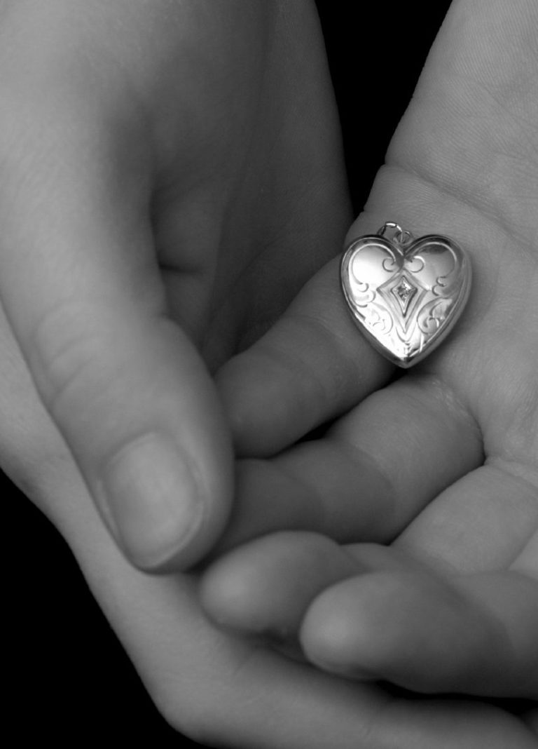 Schwarz-weiß-Landschaft mit Wellen, die sanft an einen Strand rollen unter bewölktem Himmel.